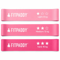 Tre rosa Fitpaddy motståndsband med motståndsnivåerna 8 kg, 12 kg och 16 kg