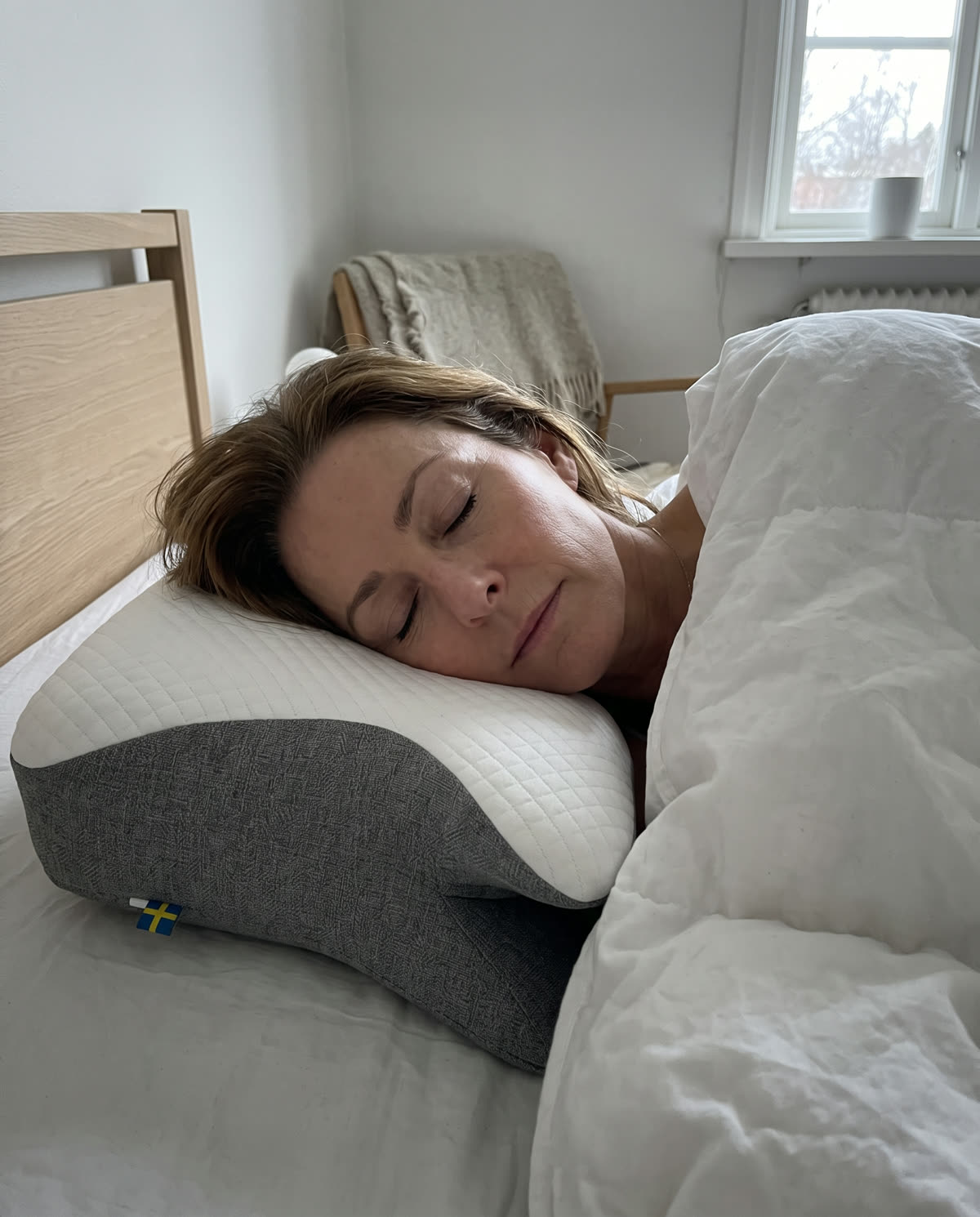 SleepEase sovkudde på en säng i morgonljus